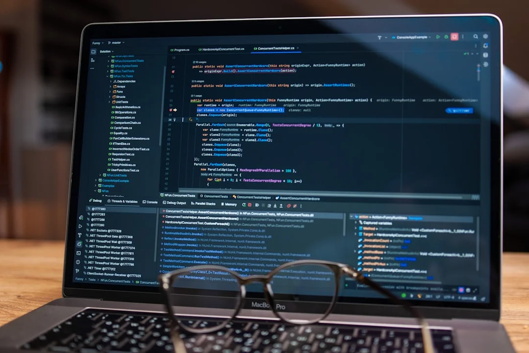 Two monitors sit on a desk, highlighting web design work in a contemporary office environment.