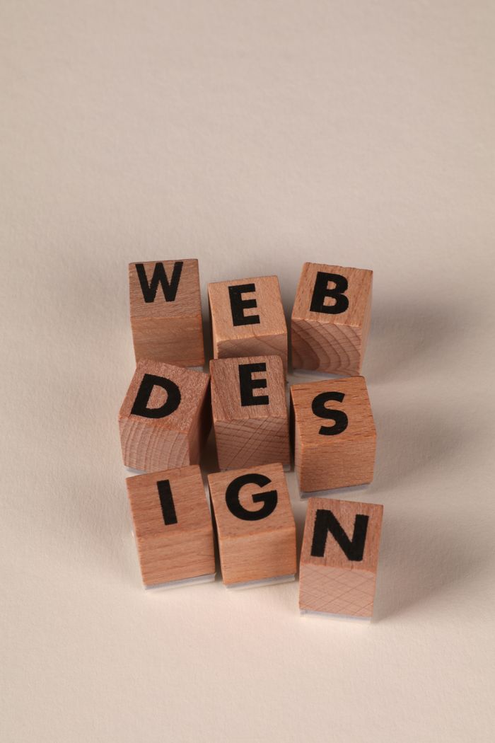 Wooden blocks laid out to form Web Design. Ideal for creative themes and digital content.